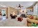 Inviting living room featuring a fireplace, ceiling fan, built-in shelving, and comfortable seating area at 2208 Walden Creek Dr, Apex, NC 27523