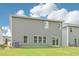 Back of home with gray vinyl siding and green lawn at 2210 Cherry Creek Rd, Haw River, NC 27258