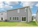 Rear view of home with gray vinyl siding and sliding glass doors at 2210 Cherry Creek Rd, Haw River, NC 27258