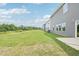 Wide backyard showing vinyl sided home, and green grass at 2210 Cherry Creek Rd, Haw River, NC 27258