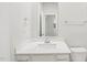 Modern bathroom featuring white quartz countertop, sleek fixtures, and a large mirror for a bright, clean look at 2210 Cherry Creek Rd, Haw River, NC 27258