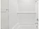 Clean and bright bathroom featuring a tiled shower, shower rod, and neutral color scheme at 2210 Cherry Creek Rd, Haw River, NC 27258