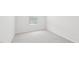 Bedroom features neutral carpet, light-colored walls, and window for natural light at 2210 Cherry Creek Rd, Haw River, NC 27258