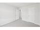 An open bedroom with light gray carpet and white walls and trim at 2210 Cherry Creek Rd, Haw River, NC 27258