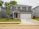 Charming two-story home with gray siding, a two-car garage, and well-maintained front yard at 2210 Cherry Creek Rd, Haw River, NC 27258