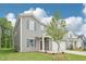 Two-story home featuring gray siding, a two-car garage and a covered front porch at 2210 Cherry Creek Rd, Haw River, NC 27258