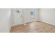 Empty flex space with luxury vinyl flooring and a white door and window at 2210 Cherry Creek Rd, Haw River, NC 27258