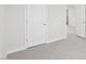 Hallway includes neutral carpet, light walls, and doors leading to other rooms at 2210 Cherry Creek Rd, Haw River, NC 27258