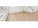 Open-concept living room with bright light, showcasing the space's neutral palette and wood flooring at 2210 Cherry Creek Rd, Haw River, NC 27258
