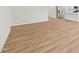 Bright living room next to the modern kitchen, showcasing the light wood floors and open design at 2210 Cherry Creek Rd, Haw River, NC 27258