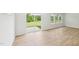 Bright living room with sliding glass door and views of the backyard, complemented by light wood floors and natural light at 2210 Cherry Creek Rd, Haw River, NC 27258