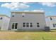 Home back exterior with sliding glass door leading to a manicured yard at 2211 Cherry Creek Rd, Haw River, NC 27258