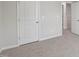 A carpeted bedroom space has a closet, neutral paint, and easy access to the rest of the house at 2211 Cherry Creek Rd, Haw River, NC 27258