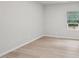 Neutral bedroom features hardwood floors and bright window letting in natural light at 2211 Cherry Creek Rd, Haw River, NC 27258