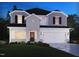 Charming two-story home with stone and siding facade, a two-car garage, and well-manicured landscaping at 2211 Cherry Creek Rd, Haw River, NC 27258