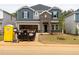 New two-story home featuring mixed siding, brick accents, an open garage and unfinished landscaping, ready for personalization at 2211 Cherry Creek Rd, Haw River, NC 27258