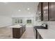 Modern kitchen boasts stainless steel appliances, a central island, and quartz countertops at 2211 Cherry Creek Rd, Haw River, NC 27258