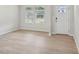 Bright living room with light wood flooring, white walls, and large windows with blinds at 2211 Cherry Creek Rd, Haw River, NC 27258