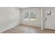 Bright living room with light wood flooring, white walls, and large windows with blinds at 2211 Cherry Creek Rd, Haw River, NC 27258