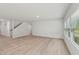 Open concept living area features hardwood floors, staircase access, and natural light at 2211 Cherry Creek Rd, Haw River, NC 27258