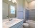 Stylish bathroom with a tub-shower combination, modern vanity, and a large mirror reflecting natural light at 229 Gilliland Rd, Siler City, NC 27344