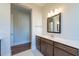 Spacious bathroom featuring a large vanity with double sinks, decorative lighting, and tile flooring at 229 Gilliland Rd, Siler City, NC 27344