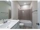 Modern bathroom featuring a tub-shower with tiled surround, chrome fixtures, and sleek vanity mirror at 229 Gilliland Rd, Siler City, NC 27344