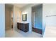 Large bathroom with double vanities, modern fixtures, stylish mirrors, and tile floors at 229 Gilliland Rd, Siler City, NC 27344