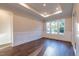 Bright dining room featuring wainscoting, tray ceiling, and large windows at 229 Gilliland Rd, Siler City, NC 27344