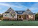 Beautiful home with a stone and siding exterior, lush lawn, and inviting front entrance at 229 Gilliland Rd, Siler City, NC 27344