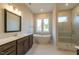 Luxury main bathroom with a freestanding tub, a large shower, double windows, and contemporary vanity at 229 Gilliland Rd, Siler City, NC 27344