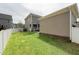 Spacious backyard with green lawn, white fence, patio, and home's exterior at 233 Airlie Dr, Chapel Hill, NC 27516