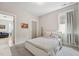 This bedroom features neutral walls, carpet and a light-filled window at 233 Airlie Dr, Chapel Hill, NC 27516