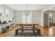 Bright dining room with a rustic wooden table and bench seating beneath a modern, spherical light fixture at 233 Airlie Dr, Chapel Hill, NC 27516