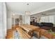 Dining area with open access to multiple living spaces, features a raw wood table and bench at 233 Airlie Dr, Chapel Hill, NC 27516