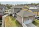 Aerial view of backyard featuring home, garage, trees and neighboring houses at 233 Airlie Dr, Chapel Hill, NC 27516