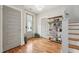 Welcoming foyer features hardwood floors, stylish bookcase, and ample natural light at 233 Airlie Dr, Chapel Hill, NC 27516