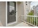 Close up of the front door with brick steps and white railing on a charming home at 233 Airlie Dr, Chapel Hill, NC 27516