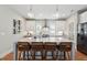 Stylish kitchen island with marble countertops, wooden bar stools, and stainless steel appliances at 233 Airlie Dr, Chapel Hill, NC 27516