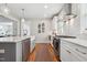 Updated kitchen with a kitchen island, marble countertops, stainless steel appliances, and white subway tile at 233 Airlie Dr, Chapel Hill, NC 27516