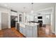 Open concept kitchen with island seating that overlooks a living room with a fireplace feature at 233 Airlie Dr, Chapel Hill, NC 27516