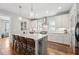 Contemporary kitchen island with seating, pendant lighting, stainless steel range hood, and a wine rack at 233 Airlie Dr, Chapel Hill, NC 27516