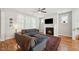 Cozy living room showcases a fireplace, hardwood floors, and comfortable seating at 233 Airlie Dr, Chapel Hill, NC 27516