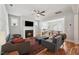 Bright living room with fireplace, hardwood floors, and an open layout to the dining area at 233 Airlie Dr, Chapel Hill, NC 27516