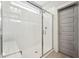 Modern shower featuring white subway tile, glass door, built-in bench, and stylish fixtures at 233 Airlie Dr, Chapel Hill, NC 27516