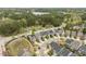 A high-angle aerial view reveals a neighborhood surrounded by lush green spaces at 237 Begen St, Morrisville, NC 27560