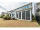 View of the home's backyard showcasing a screened-in porch and well-maintained outdoor space at 237 Begen St, Morrisville, NC 27560