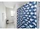 Bright bathroom with a whale-themed shower curtain, tiled floors, and fresh white towels at 237 Begen St, Morrisville, NC 27560