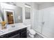Modern bathroom with a glass-enclosed shower, a dark vanity, and subway tile at 237 Begen St, Morrisville, NC 27560