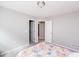 Light-filled bedroom with neutral carpet, multiple entry doors and windows with views of the neighborhood at 237 Begen St, Morrisville, NC 27560